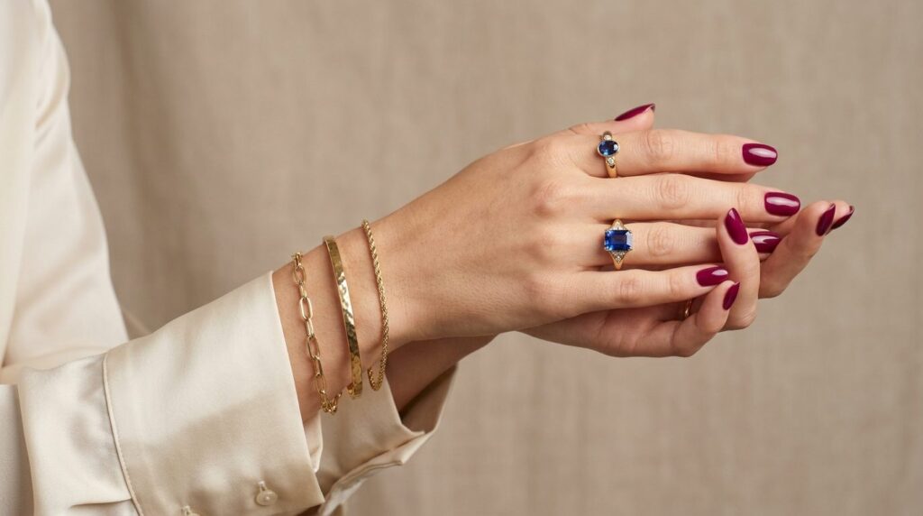 Side profile portrait of elegant manicured hands adorned wit